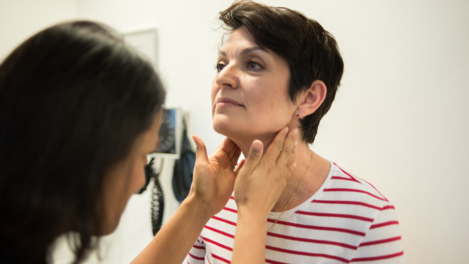 GP checking patient's glands